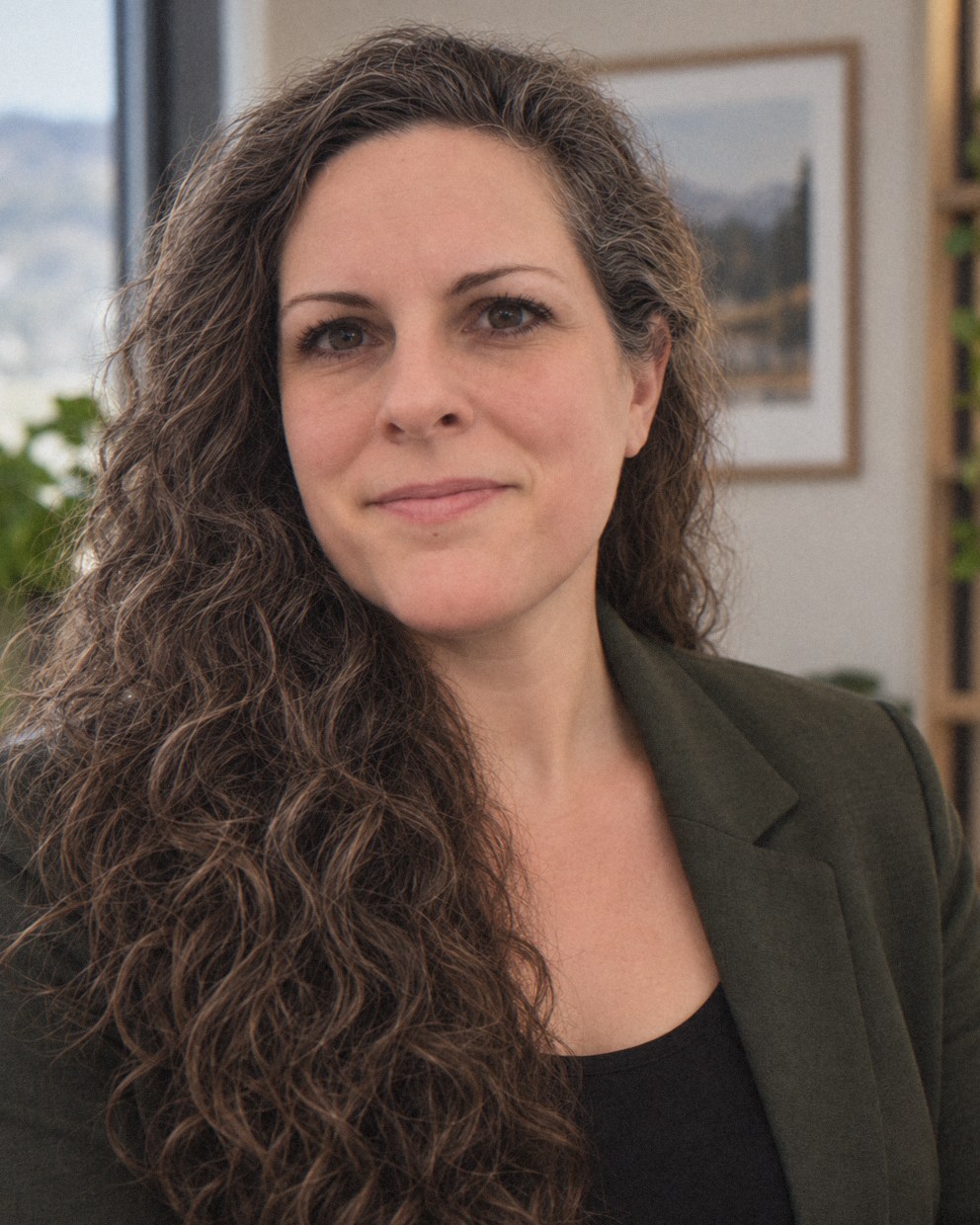 Portrait of Rebecca, smiling, in her office